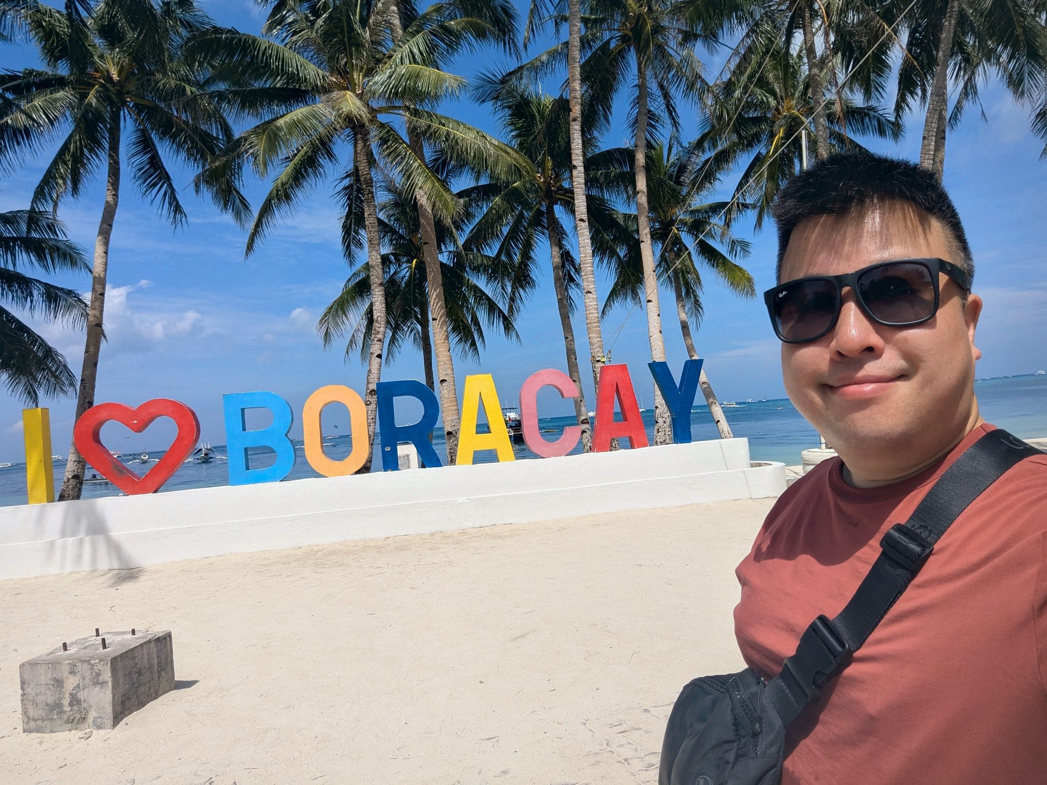 Selfie in front of the colourful I love Boracay letters under the palm trees